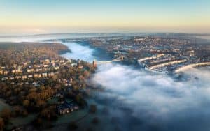 Clifton suspension bridge emerging from fog in Bristol at sunrise